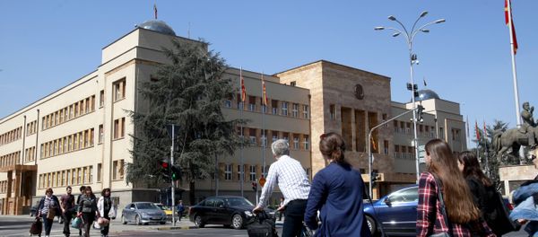 People walk across a street in front of the Parliament building in Macedonia’s capital Skopje, Thursday, April 7, 2016 People walk across a street in front of the Parliament building in Macedonia’s capital Skopje, Thursday, April 7, 2016 - Sputnik International