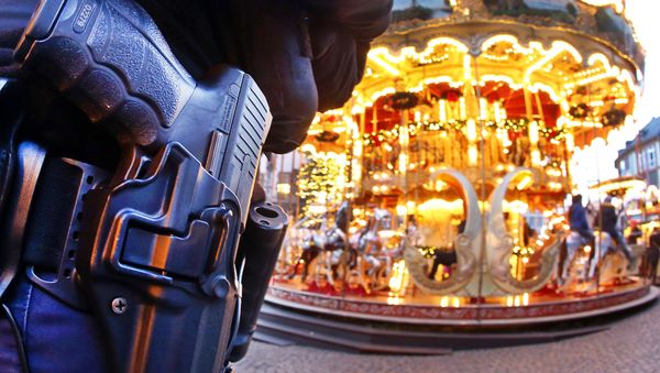 A German police officer stands next to a merry-go-round in the Christmas market in Frankfurt, Germany, Tuesday, Dec. 20, 2016 one day after a truck ran into a crowded Christmas market in Berlin killing several people A German police officer stands next to a merry-go-round in the Christmas market in Frankfurt, Germany, Tuesday, Dec. 20, 2016 one day after a truck ran into a crowded Christmas market in Berlin killing several people - Sputnik International