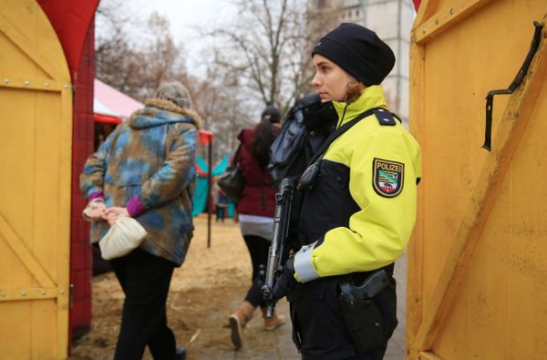 A police officer guards the entrance to a Christmas market in Magdeburg, Germany - Sputnik International
