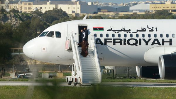 Group of hostages being released from the Afriqiyah Airways A320 after it was hijacked from Libya - Sputnik International