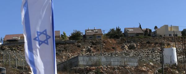Israeli national flag flying next to an Israeli building site of new housing units in the Jewish settlement of Shilo in the occupied Palestinian West Bank. (File) Israeli national flag flying next to an Israeli building site of new housing units in the Jewish settlement of Shilo in the occupied Palestinian West Bank. (File) - Sputnik International