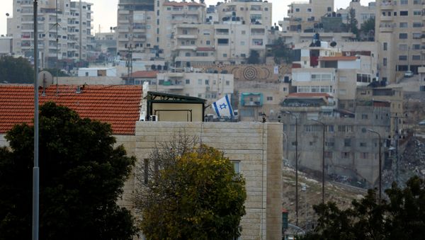A building can be seen in the Israeli settlement of Maale Edumim, in the occupied West Bank, in the background the Palestinian village of Azariya is seen on the edge of Jerusalem, December 24, 2016 A building can be seen in the Israeli settlement of Maale Edumim, in the occupied West Bank, in the background the Palestinian village of Azariya is seen on the edge of Jerusalem, December 24, 2016 - Sputnik International