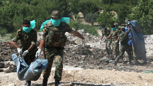 Syrian army troops remove corpses from a mass grave (File) Syrian army troops remove corpses from a mass grave (File) - Sputnik International