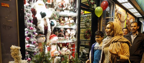 Iranians walk past Christmas decoration at a shop in the capital Tehran on December 24, 2016, on Christmas eve Iranians walk past Christmas decoration at a shop in the capital Tehran on December 24, 2016, on Christmas eve - Sputnik International