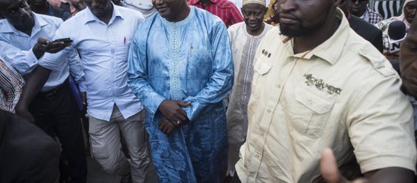 Gambia President elect, Adama Barrow, centre, walks after a meeting with Ecowas delegation in Banjul, Gambia, Tuesday, Dec. 13, 2016. Gambia's ruling party pressed for fresh elections, as West African regional mediators intervened Tuesday to try to resolve a political crisis in the tiny West African country that voted its leader of 22 years from power. (AP Photo/ Sylvain Cherkaoui) Gambia President elect, Adama Barrow, centre, walks after a meeting with Ecowas delegation in Banjul, Gambia, Tuesday, Dec. 13, 2016. Gambia's ruling party pressed for fresh elections, as West African regional mediators intervened Tuesday to try to resolve a political crisis in the tiny West African country that voted its leader of 22 years from power. (AP Photo/ Sylvain Cherkaoui) - Sputnik International