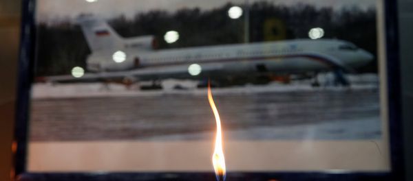 A candle is placed in front of a picture of Tu-154 plane, to commemorate passengers and crew members of Russian military plane, which crashed into the Black Sea on its way to Syria on Sunday, at the Sochi International Airport (Sochi-Adler Airport) in the Black Sea resort city of Sochi, Russia, December 26, 2016 A candle is placed in front of a picture of Tu-154 plane, to commemorate passengers and crew members of Russian military plane, which crashed into the Black Sea on its way to Syria on Sunday, at the Sochi International Airport (Sochi-Adler Airport) in the Black Sea resort city of Sochi, Russia, December 26, 2016 - Sputnik International