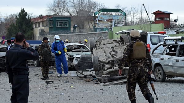 Afghan police and security personnel inspect the scene of a suicide car bomb attack near a district police headquarters in the centre of the Afghan capital Kabul Afghan police and security personnel inspect the scene of a suicide car bomb attack near a district police headquarters in the centre of the Afghan capital Kabul - Sputnik International