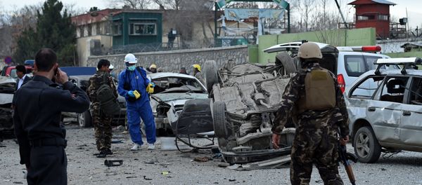 Afghan police and security personnel inspect the scene of a suicide car bomb attack near a district police headquarters in the centre of the Afghan capital Kabul Afghan police and security personnel inspect the scene of a suicide car bomb attack near a district police headquarters in the centre of the Afghan capital Kabul - Sputnik International