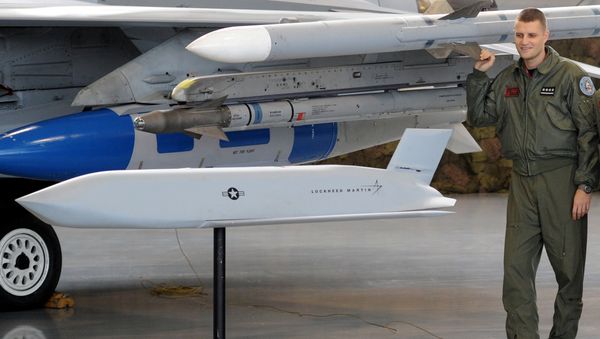 A Polish Air Force pilot looks at a model of a JASSM missile prior to a contract signing ceremony of 40 Lockheed Martin’s joint air-to-surface standoff missiles (JASSM), as well as F-16 fighter plane operational flight plan upgrades, associated equipment, parts, training and logistical support, between Poland and U.S., at a Polish Air Force base in Poznan, Poland, Thursday, Dec. 11, 2014 - Sputnik International