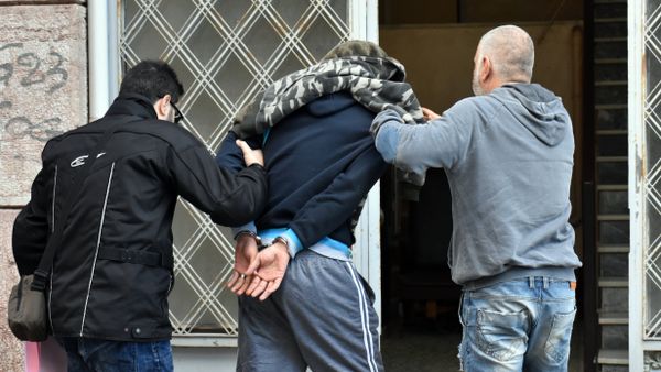 A Syrian man is escorted by police officers before a prosecutor on the island of Chios on December 14, 2016 after being suspected of brutally beating a three-year-old refugee boy in a camp shower - Sputnik International