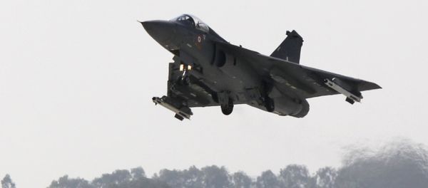 An Indian Light Combat Aircraft (LCA) 'Tejas' flies during an 'Initial Operational Clearance' procedure before induction into The Indian Air Force (IAF) at Hindustan Aeronautical Ltd. (HAL) airport in Bangalore on January 10, 2011 - Sputnik International