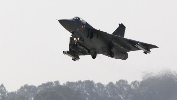 An Indian Light Combat Aircraft (LCA) 'Tejas' flies during an 'Initial Operational Clearance' procedure before induction into The Indian Air Force (IAF) at Hindustan Aeronautical Ltd. (HAL) airport in Bangalore on January 10, 2011 - Sputnik International