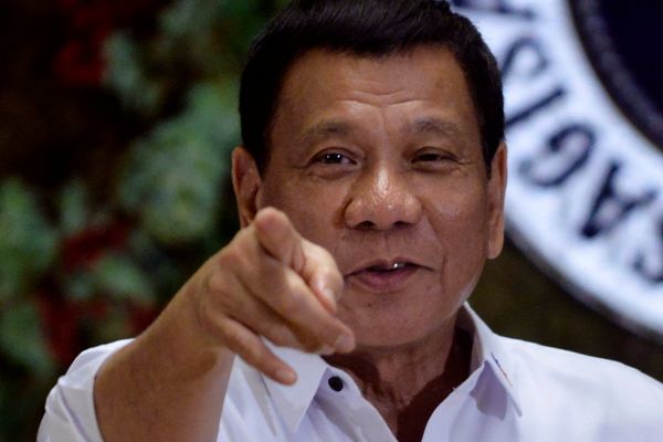 Philippine President Rodrigo Duterte points to photographers during an awarding ceremony for outstanding government workers, at the Malacanang Palace in Manila, Philippines December 19, 2016 - Sputnik International
