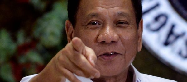 Philippine President Rodrigo Duterte points to photographers during an awarding ceremony for outstanding government workers, at the Malacanang Palace in Manila, Philippines December 19, 2016 Philippine President Rodrigo Duterte points to photographers during an awarding ceremony for outstanding government workers, at the Malacanang Palace in Manila, Philippines December 19, 2016 - Sputnik International