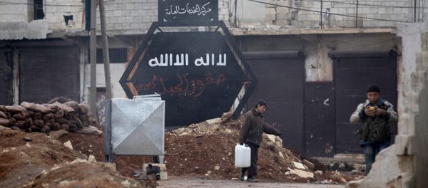 A boy carries a water container near a sign that used to belong to the Islamic State in al-Rai town, northern Aleppo countryside, Syria December 25, 2016 A boy carries a water container near a sign that used to belong to the Islamic State in al-Rai town, northern Aleppo countryside, Syria December 25, 2016 - Sputnik International