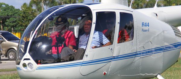 Then-local mayor of Davao city Rodrigo Duterte (R), aboard a helicopter, arrives at the provincial capitol in Tagum city, Davao del Norte, southern Philippines for the Regional Peace and Order Council meeting, April 20, 2015 - Sputnik International