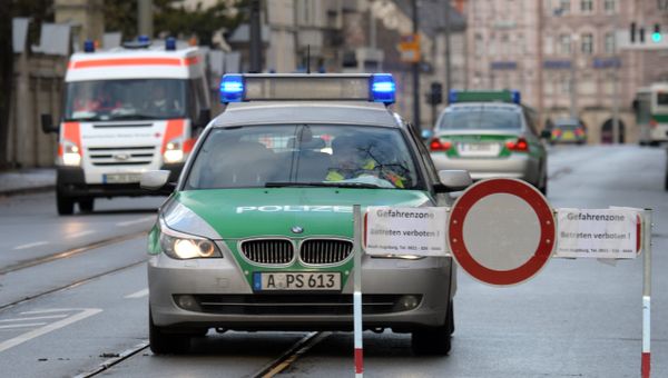 Police cars are seen beside a road block on an empty street in Augsburg, southern Germany Police cars are seen beside a road block on an empty street in Augsburg, southern Germany - Sputnik International