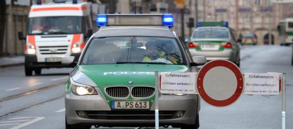Police cars are seen beside a road block on an empty street in Augsburg, southern Germany - Sputnik International