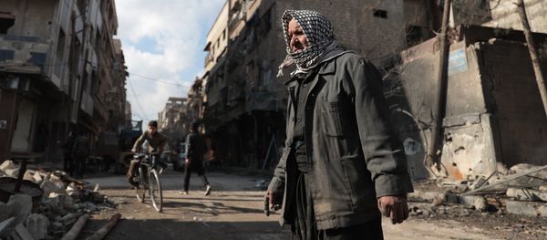 Syrian Abu Khaled looks at the rubble of his destroyed house in the rebel-held town of Douma, on the eastern outskirts of Damascus, on December 30, 2016, on the first day of a nationwide truce - Sputnik International