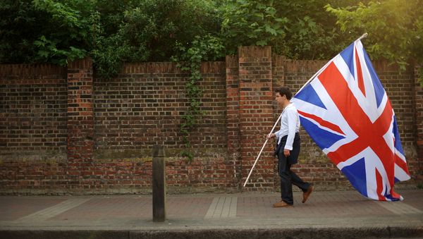 Young man in London carrying the Union Jack Young man in London carrying the Union Jack - Sputnik International