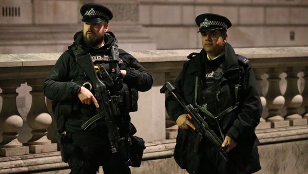 Armed British police officers stand on duty ahead of the New Year's celebrations, in central London. Armed British police officers stand on duty ahead of the New Year's celebrations, in central London. - Sputnik International