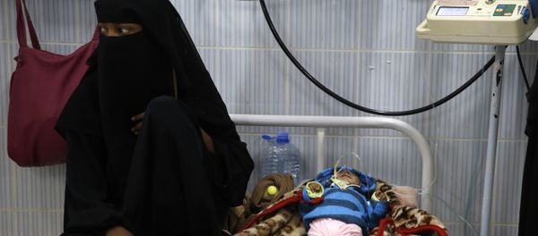 A woman sits next to her malnourished baby at a therapeutic feeding center in a hospital in Sanaa, Yemen. There have been numerous reported cases of dying from starvation in Yemeni hospitals. A woman sits next to her malnourished baby at a therapeutic feeding center in a hospital in Sanaa, Yemen. There have been numerous reported cases of dying from starvation in Yemeni hospitals. - Sputnik International