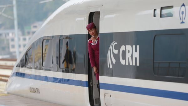 A staff looks out from a high-speed railway train linking Shanghai and Kunming, of Yunnan province, after a partial operation, in Guanling, Guizhou province, China, December 28, 2016. Picture taken December 28, 2016 A staff looks out from a high-speed railway train linking Shanghai and Kunming, of Yunnan province, after a partial operation, in Guanling, Guizhou province, China, December 28, 2016. Picture taken December 28, 2016 - Sputnik International