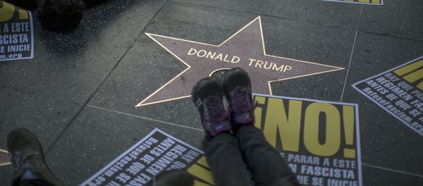 People hold a die-in protest at the Hollywood Walk of Fame star for Donald Trump on Christmas Day in reaction against a Twitter post by US President-elect Trump referring to expansion of the United States nuclear arsenal on December 25 in Los Angeles, California People hold a die-in protest at the Hollywood Walk of Fame star for Donald Trump on Christmas Day in reaction against a Twitter post by US President-elect Trump referring to expansion of the United States nuclear arsenal on December 25 in Los Angeles, California - Sputnik International