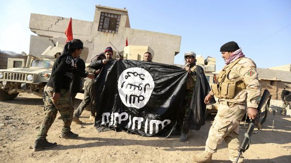  Iraqi Army soldiers celebrate as they hold a flag of the Islamic State group they captured during a military operation to regain control of a village outside Mosul, Iraq (File) - Sputnik International