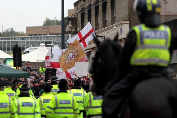 Police officers stand guard as members of the English Defence League (EDL) demonstrate on Bridge Street in Bradford city centre, west Yorkshire, on October 12, 2013. Police officers stand guard as members of the English Defence League (EDL) demonstrate on Bridge Street in Bradford city centre, west Yorkshire, on October 12, 2013. - Sputnik International