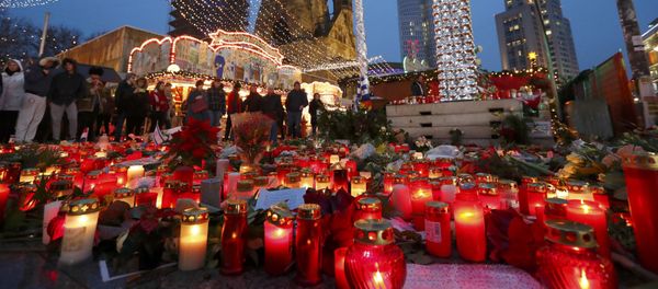 Flowers and candles are placed near the Christmas market at Breitscheid square in Berlin, Germany, December 22, 2016, following an attack by a truck which ploughed through a crowd at the market on Monday night Flowers and candles are placed near the Christmas market at Breitscheid square in Berlin, Germany, December 22, 2016, following an attack by a truck which ploughed through a crowd at the market on Monday night - Sputnik International