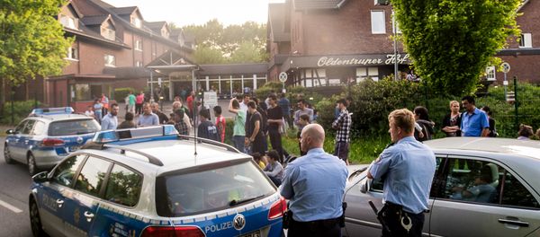 In this May 21, 2016 picture police and refugees stand near a refugee shelter in Bielefeld, Germany In this May 21, 2016 picture police and refugees stand near a refugee shelter in Bielefeld, Germany - Sputnik International