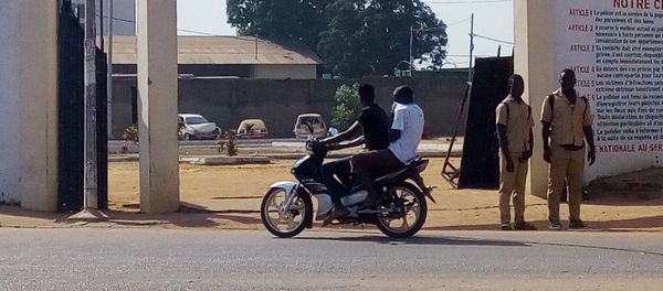 A man rides a motorcycle while two soldiers stand in front of the prefecture of police in Bouake on January 6, 2017 A man rides a motorcycle while two soldiers stand in front of the prefecture of police in Bouake on January 6, 2017 - Sputnik International