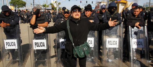 A demonstrator gestures in front of policemen as a group of them blocked the entrance of a Pemex gas storage station during a protest against the rising prices of gasoline enforced by the Mexican government, in Rosarito, Mexico, January 7, 2017. - Sputnik International