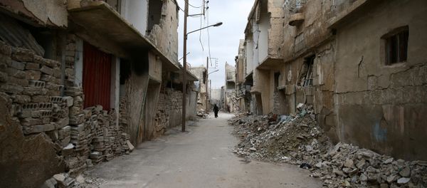 A woman walks past damaged buildings in the rebel held besieged city of Douma, in the eastern Damascus suburb of Ghouta, Syria A woman walks past damaged buildings in the rebel held besieged city of Douma, in the eastern Damascus suburb of Ghouta, Syria - Sputnik International