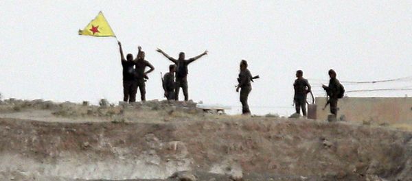 Kurdish fighters with the Kurdish People's Protection Units, or YPG, wave their yellow triangular flag in the outskirts of Tal Abyad, Syria. (File) - Sputnik International