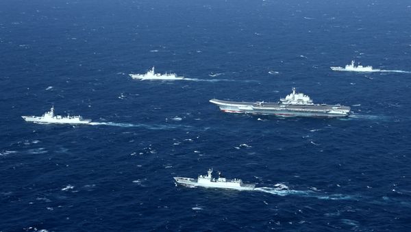 China's Liaoning aircraft carrier with accompanying fleet conducts a drill in an area of South China Sea in this undated photo taken December, 2016 - Sputnik International