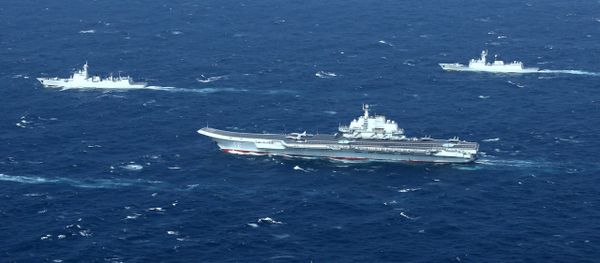 China's Liaoning aircraft carrier with accompanying fleet conducts a drill in an area of South China Sea in this undated photo taken December, 2016 - Sputnik International
