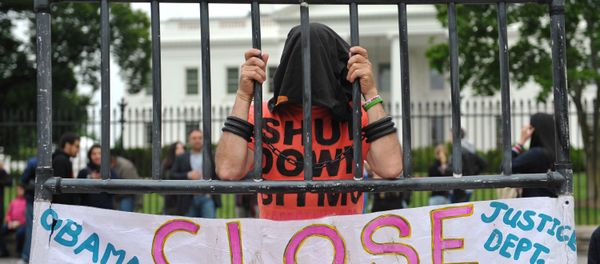 A hooded demonstrator is seen at a protest calling for the closure of the Guantanamo Bay detention facility in front of the White House on May 18, 2013 in Washington, DC. A hooded demonstrator is seen at a protest calling for the closure of the Guantanamo Bay detention facility in front of the White House on May 18, 2013 in Washington, DC. - Sputnik International