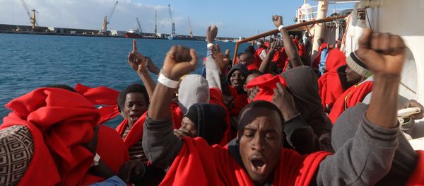 Migrants celebrate on board the former fishing trawler Golfo Azzurro as they arrive at the port of Pozzallo in Sicily, two days after they were rescued by the Spanish NGO Proactiva Open Arms after the raft they were on drifted out of control in the central Mediterranean Sea, January 4, 2017 Migrants celebrate on board the former fishing trawler Golfo Azzurro as they arrive at the port of Pozzallo in Sicily, two days after they were rescued by the Spanish NGO Proactiva Open Arms after the raft they were on drifted out of control in the central Mediterranean Sea, January 4, 2017 - Sputnik International