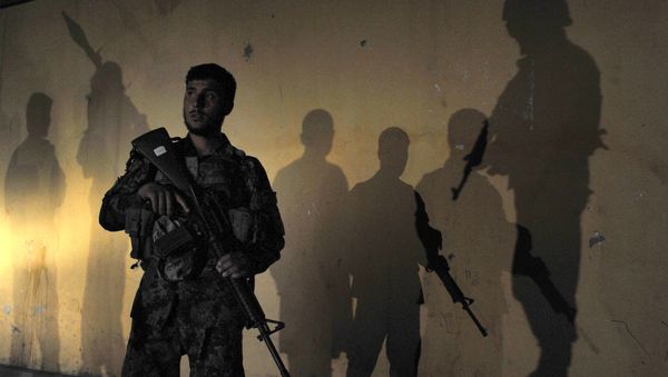 An Afghan security official is surrounded by the shadows of colleagues (File) - Sputnik International