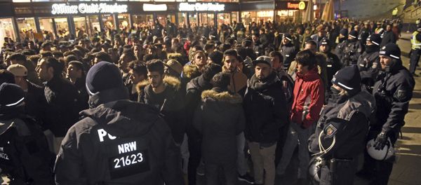 Police officers surround a group of men in front of the Cologne, western Germany, main station, Saturday, Dec. 31, 2016 Police officers surround a group of men in front of the Cologne, western Germany, main station, Saturday, Dec. 31, 2016 - Sputnik International