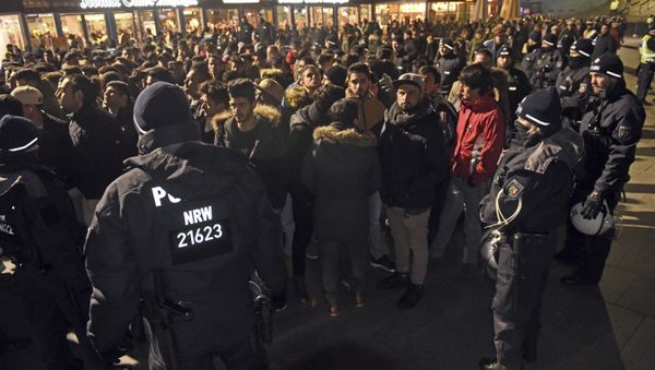 Police officers surround a group of men in front of the Cologne, western Germany, main station, Saturday, Dec. 31, 2016 Police officers surround a group of men in front of the Cologne, western Germany, main station, Saturday, Dec. 31, 2016 - Sputnik International