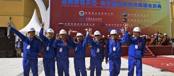 Chinese workers pose at the inauguration site of a train linking Addis Ababa to Djibouti, 20 kilometres from the centre of Addis Ababa on October 5, 2016 - Sputnik International