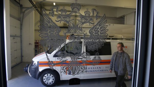 In this Thursday, Sept. 29, 2016 photo, a worker passes by a rescue mission van in a warehouse in a Russian-Serbian Humanitarian Center near an airport in the town of Nis, Serbia - Sputnik International