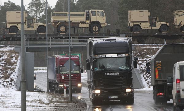 American military vehicles are transported by train cross a bridge in Zagan Poland, on Thursday, Jan. 12, 2017 American military vehicles are transported by train cross a bridge in Zagan Poland, on Thursday, Jan. 12, 2017 - Sputnik International