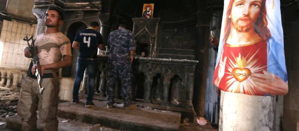 Iraqi Christian forces inspect the damage at the Church of the Immaculate Conception on October 30, 2016 in the town of Qaraqosh (also known as Hamdaniya), 30 kms east of Mosul, after Iraqi forces recaptured it from Islamic State (IS) group jihadists. Iraqi Christian forces inspect the damage at the Church of the Immaculate Conception on October 30, 2016 in the town of Qaraqosh (also known as Hamdaniya), 30 kms east of Mosul, after Iraqi forces recaptured it from Islamic State (IS) group jihadists. - Sputnik International