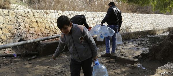 Syrians fill plastic containers with water at a public fountain in the capital Damascus on January 10, 2017 - Sputnik International