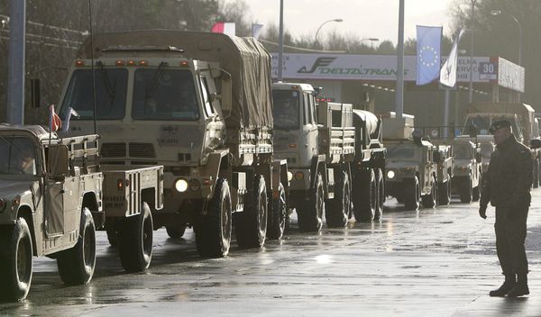 U.S. Army vehicles cross the Polish border in Olszyna, Poland, Thursday, Jan. 12, 2017 heading for their new base in Zagan - Sputnik International