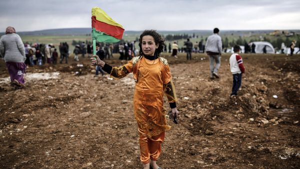 A Syrian Kurdish young woman holds the flag of the Syrian Kurdish Democratic Union Party (PYD) (File) - Sputnik International